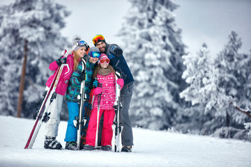 Family on ski holiday in mountains enjoying and have fun
