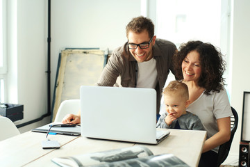 Young happy family relaxing at home at the table