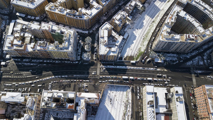 Aerial view of a group of buildings in the Tuscolana district in Rome, Italy. The buildings and streets are unusually covered with snow and ice.The roofs are passable and with antennas and TV dishes.