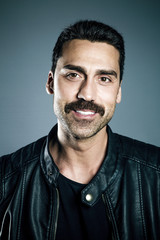 Young handsome man with beard and mustache studio portrait