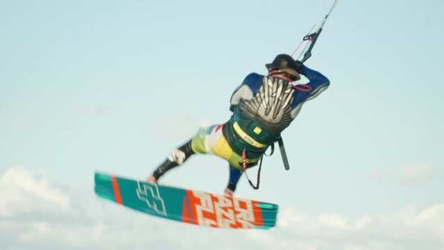 Man Kitesurfing In Ocean In Summer Does Extreme Trick