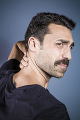 Obraz premium Young handsome man having neck problems