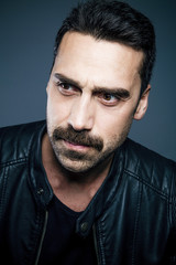 Young handsome man with beard and mustache studio portrait