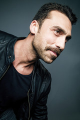 Young handsome man with beard and mustache studio portrait