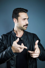 Young handsome man with beard and mustache studio portrait