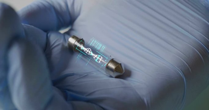 A scientist in his laboratory holds a test tube containing DNA and is able to control the evolution of man thanks to holography. Concept of: DNA, technology, augmented reality.