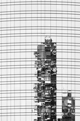 Obraz premium Reflection in the mirror of a modern glass skyscraper with geometric lines, Milan.