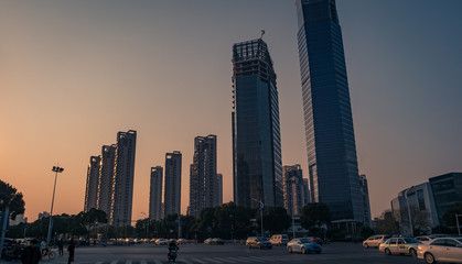 Bottom view of modern skyscrapers at sunset