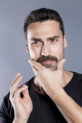 Young handsome man with beard and mustache studio portrait