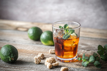 Glass of rum on the wooden background