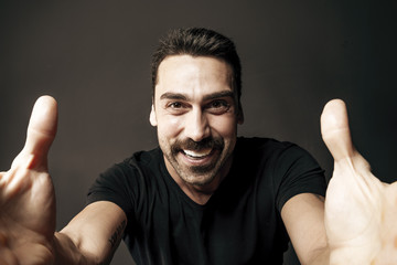 Young handsome man with beard and mustache studio portrait