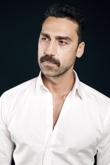 Obraz premium Young handsome man with beard and mustache studio portrait