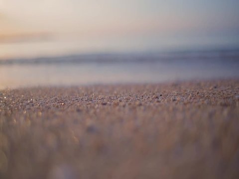 wave on the sand of bali beach close-up with shallow depth of field