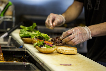 A chef preparing a hamburger