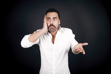 Man with moustache showing an anxious facial expression