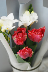 Beautiful bouquet of pink tulips and Freisia Flowers on wooden background. Spring bouquet for Gift with Copy Space.