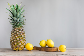 pinneapple and lemons on white background
