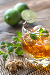 Glass of rum on the wooden background