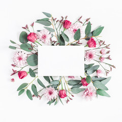 Flowers composition. Paper blank, various pink flowers and eucalyptus branches on white background. Flat lay, top view, square, copy space
