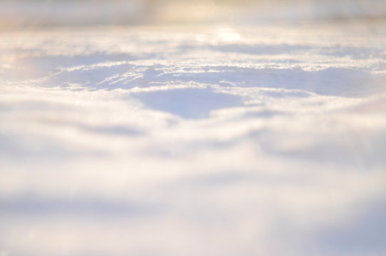 background texture of the snow in the sun at sunset