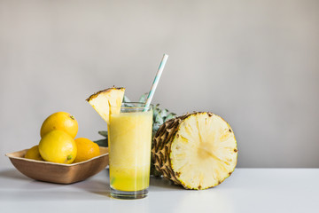 pineapple juice with pineapple in backround
