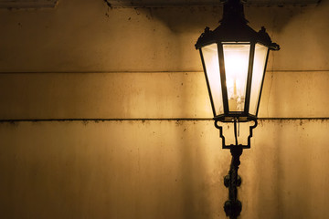 Traditional street lamp on wall on a street in the Old Town of Prague, Czech Republic. Copy space