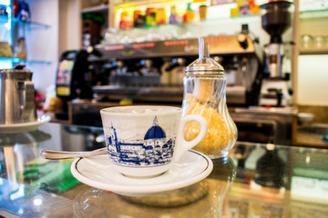 Florence, Tuscany/Italy - March 3, 2018. coffee shop on the bar is a white small Cup of espresso coffee. on the Cup painted symbol of Florence Cathedral of Santa Maria del Fiore.