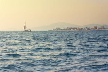 Yacht sailing by the sea in the evening