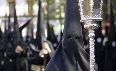 religious processions, with hooded people representing the penitents