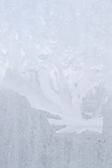 Fototapeta na wymiar Winter frosty patterns on the frozen ice window