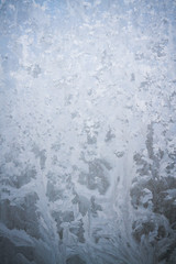 Winter frosty patterns on the frozen ice window