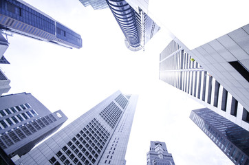 Obraz na płótnie Canvas Modern business skyscrapers, high-rise buildings, architecture raising to the sky, sun. Concepts of financial, economics, future etc.
