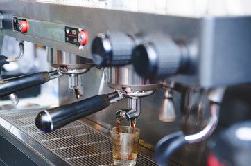 Fototapeta na wymiar prepares espresso in his coffee shop ; close-up , vintage tone