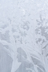 Winter frosty patterns on the frozen ice window