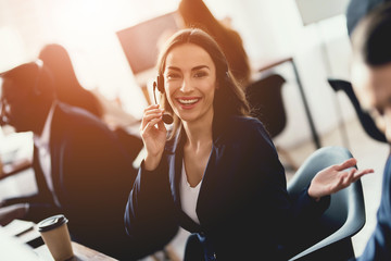 Caucasian girl looks at work in the call center.