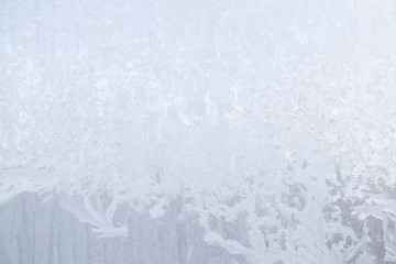 Winter frosty patterns on the frozen ice window
