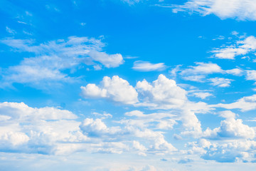 Bright sunny clouds on a blue sky. Heavenly background. Universal template for background insertion.