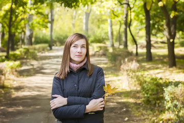 Fototapeta premium Young woman in park, lonely, thinking about something