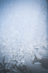 Winter frosty patterns on the frozen ice window