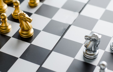 silver and gold knight on chess board. Chess knights head to head.Business concept opponent in business . or  Business Cooperation