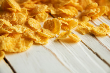 Golden crisp cereal for Breakfast on a white wooden background