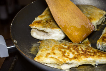 Preparation of homemade fried fish hake on a frying pan. The concept of natural cooking.