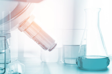 three erlenmeyer flask and microscope , Glassware on  science laboratory research and development