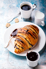   Breakfast Continental  with Fresh  Croissants on a blue Background Coffee  and milk Delicious Baking with  with Chocolate Topping