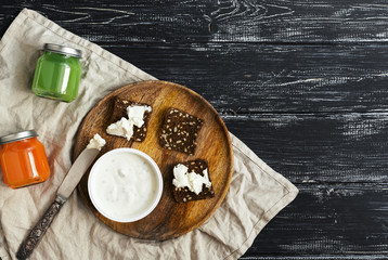 Breakfast, cheese with rye bread and fresh orange and kiwi juices. A wooden background, top view. Copy space.
