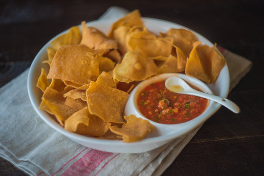 Spicy red salsa with a plate of tortilla chips