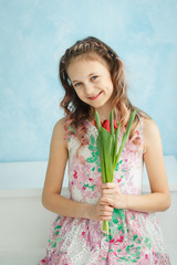 Adorable smiling teenager girl with tulips