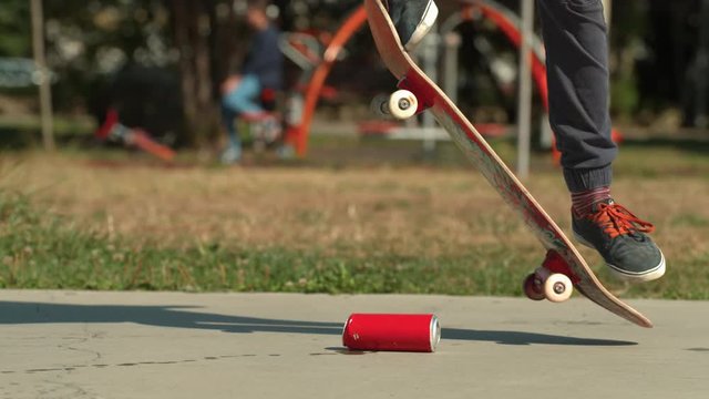 Crushing a can with the skateboard, slow motion
