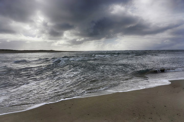 Turbulent water where the outgoing river current meets and incoming ocean tide