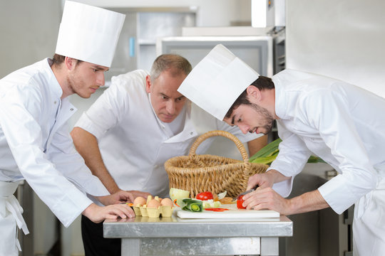 professional chefs preparing a dish at restaurant